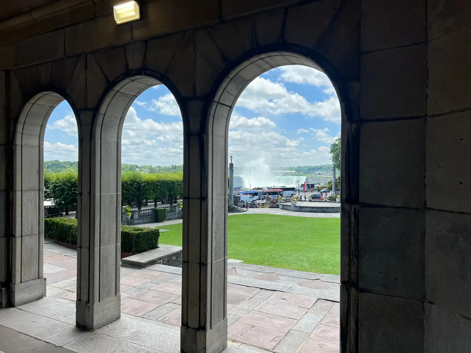 Niagara Falls park walkway lined with trees and visitors
