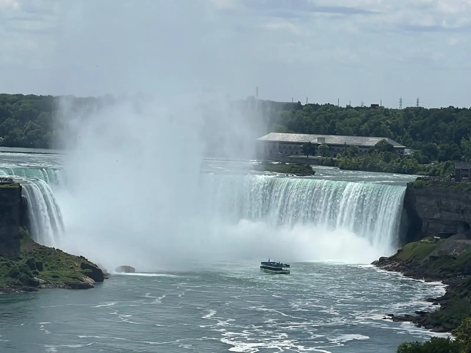 Niagara Falls with tour boat in the basin
