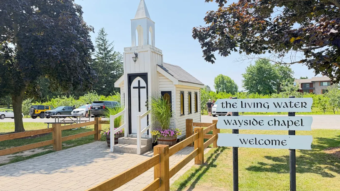 The Living Water Wayside Chapel and its welcome sign in Niagara wine country